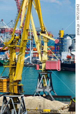 industrial seaport infrastructure, sea, cranes and dry cargo ship, grain silo, bulk carrier vessel and grain storage elevators, concept of sea cargo transportation 96721042