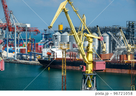 industrial seaport infrastructure, sea, cranes and dry cargo ship, grain silo and bulk carrier vessel, concept of sea cargo transportation industrial seaport infrastructure, sea, cranes and dry cargo ship, grain silo and bulk carrier vessel, concept of sea cargo transportation 96721058