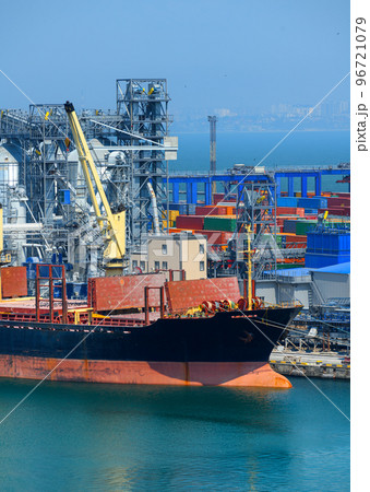 industrial seaport infrastructure, sea, cranes and dry cargo ship, grain silo, bulk carrier vessel and grain storage elevators, concept of sea cargo transportation industrial seaport infrastructure, sea, cranes and dry cargo ship, grain silo, bulk carrier vessel and grain storage elevators, concept of sea cargo transportation 96721079