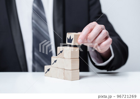 Wooden blocks with black arrows icons and crown, business profit growth success concept 96721269