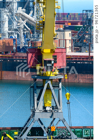 Odessa, Ukraine, May 4, 2019 - industrial seaport infrastructure, sea, cranes and dry cargo ship, grain silo, bulk carrier vessel and grain storage elevators, concept of sea cargo transportation Odessa, Ukraine, May 4, 2019 - industrial seaport infrastructure, sea, cranes and dry cargo ship, grain silo, bulk carrier vessel and grain storage elevators, concept of sea cargo transportation 96721365