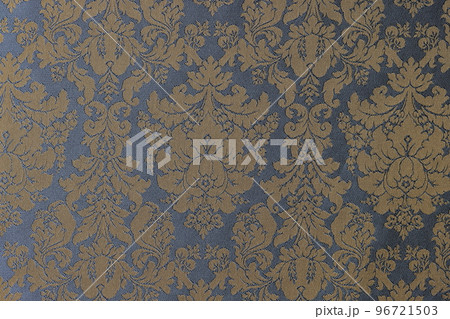Golden-blue fabric with ornament of flowers and leaves as background. 96721503