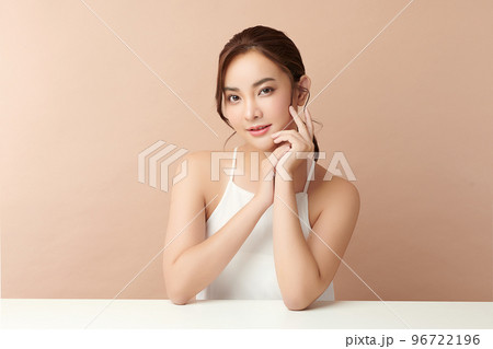 Beautiful young asian woman with clean fresh skin on beige background, Face care, Facial treatment, Cosmetology, beauty and spa, Asian women portrait. Beautiful young asian woman with clean fresh skin on beige background, Face care, Facial treatment, Cosmetology, beauty and spa, Asian women portrait. 96722196