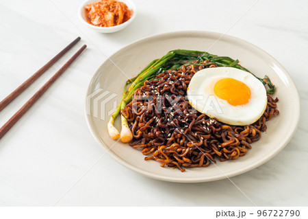 dried Korean spicy black sauce instant noodles with fried egg and kimchi 96722790