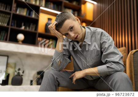 portrait of strong caucasian woman with short haircut in cozy interior 96723672