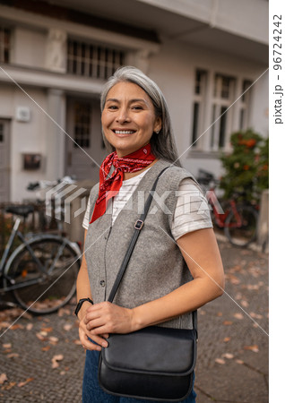 Cute woman in the city street looking contented and happy 96724242