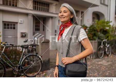 Cute woman in the city street looking contented and happy 96724243