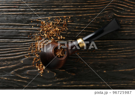 Smoking pipe with tobacco on wooden background 96725987