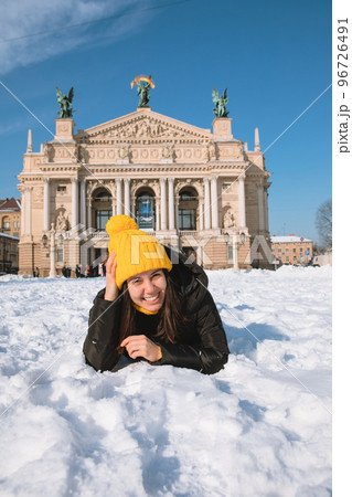 happy woman traveler in front of opera building in lviv city 96726491