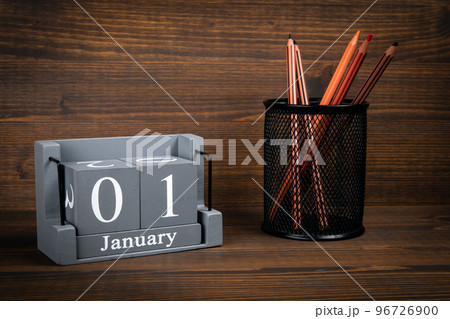 1 January inscription on wooden calendar. Wooden office desk 96726900