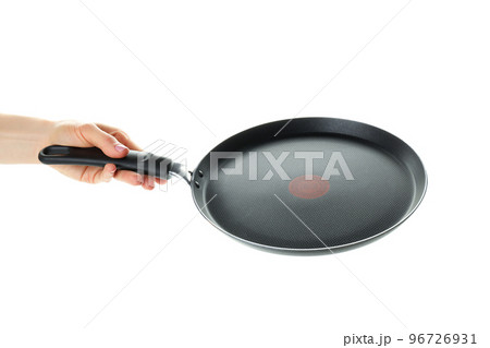 Female hand holds pan, isolated on white background Female hand holds pan, isolated on white background 96726931