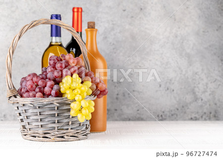Ripe grape in basket and wine bottles 96727474