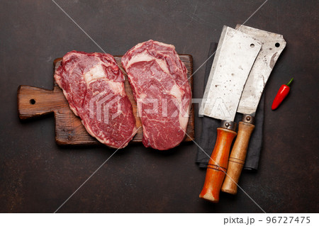 Two raw ribeye beef steaks 96727475