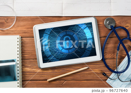 Web security and technology concept with tablet pc on wooden table Web security and technology concept with tablet pc on wooden table 96727640