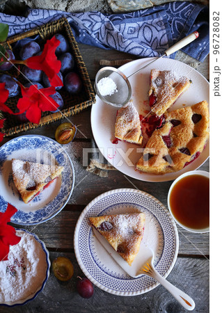Homemade plum pie and cup of tea. New York Times recipe plum cake 96728082