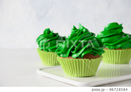 Homemade chocolate cupcake with with green whipped cream. Homemade chocolate cupcake with with green whipped cream. 96728584