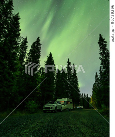 Aurora shining over Camping Caravan in Swedish forest Tannforsen Waterfall Northern Lights color sky Sweden, Scandinavia 96729296