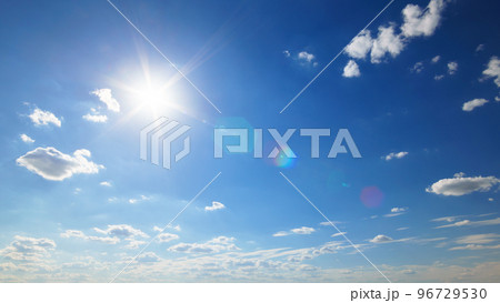 beautiful blue sky with sun and clouds on bright sunny day for abstract background beautiful blue sky with sun and clouds on bright sunny day for abstract background 96729530
