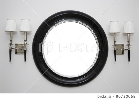 Mirror and lamps on a light white wall 96730668