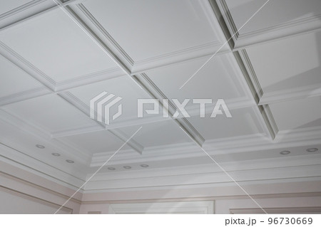 Ceiling moldings in the interior, detail of a angular ceiling skirting and lamps Ceiling moldings in the interior, detail of a angular ceiling skirting and lamps 96730669