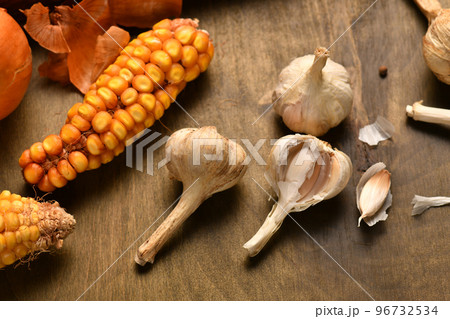 still life of food in a rural style on a dark wood background, corn and garlic, concept of fresh vegetables and healthy food 96732534