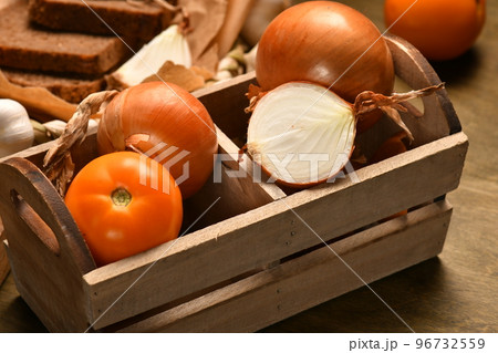still life of food in a rural style on a dark wood background, rye bread and garlic, tomatoes and onion, concept of fresh vegetables and healthy food 96732559