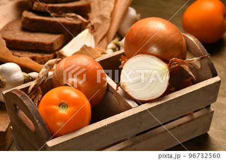 still life of food in a rural style on a dark wood background, rye bread and garlic, tomatoes and onion, concept of fresh vegetables and healthy food 96732560