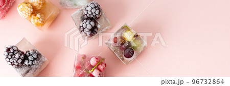 Frozen ice cubes with various berries Frozen ice cubes with various berries 96732864