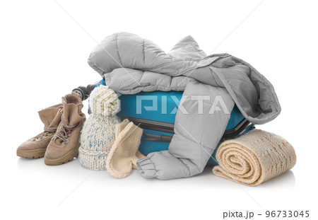 Suitcase with warm clothes isolated on white. Winter vacation Suitcase with warm clothes isolated on white. Winter vacation 96733045