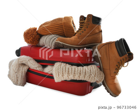 Suitcase with warm clothes isolated on white. Winter vacation Suitcase with warm clothes isolated on white. Winter vacation 96733046