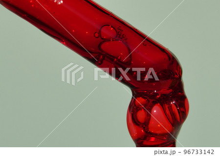 The drop in the pipette of blood. The concept of developing a pharmaceutical drug for the treatment of diseases with the help of drugs that improve DNA on light green background with copy space. 96733142