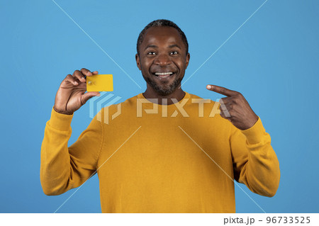 Happy african american mature man pointing at credit card Happy african american mature man pointing at credit card 96733525