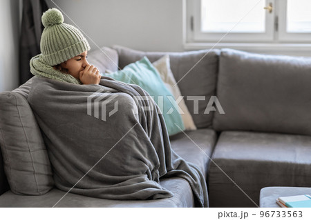 Energy Crisis. Portrait Of Woman Covered In Warm Blanket Sitting On Couch 96733563