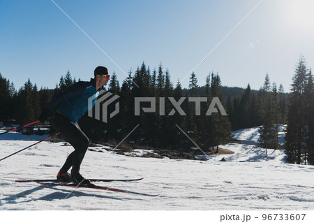 Nordic skiing or Cross-country skiing classic technique practiced by man in a beautiful panoramic trail at morning. Nordic skiing or Cross-country skiing classic technique practiced by man in a beautiful panoramic trail at morning. 96733607