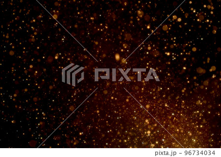 Natural organic golden dust particles floating on black background. Glittering sparkling flickering glowing. Natural organic golden dust particles floating on black background. Glittering sparkling flickering glowing. 96734034