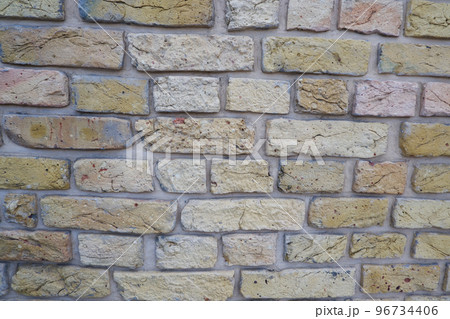 Peeled old brick wall. Brick yellow background. 96734406
