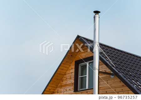 Chimney without smoke on the roof of a wooden house, cottage Chimney without smoke on the roof of a wooden house, cottage 96735257