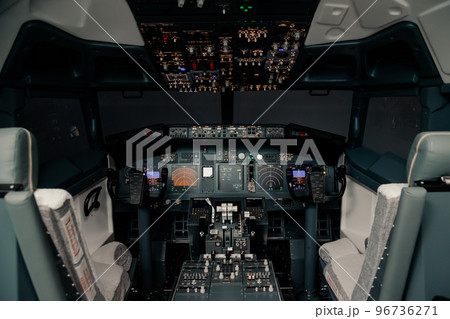 Empty pilot Cockpit with switched on Flight Deck dashboard in night, without people Empty pilot Cockpit with switched on Flight Deck dashboard in night, without people 96736271
