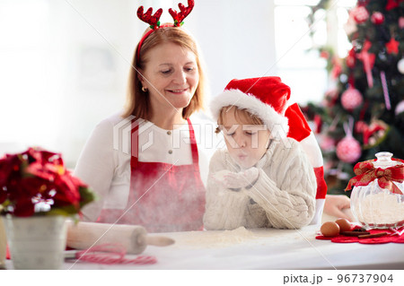 Family baking Christmas cookies. Kids Xmas fun. 96737904