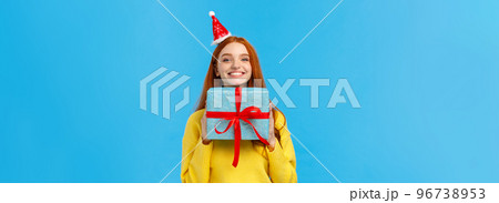 Excited and happy cute redhead girlfriend enjoy celebrating christmas, secret santa event as receive lots gifts, holding present, bragging with blue wrapped new year gift, smiling joyfully Excited and happy cute redhead girlfriend enjoy celebrating christmas, secret santa event as receive lots gifts, holding present, bragging with blue wrapped new year gift, smiling joyfully 96738953