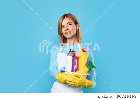 woman in gloves holding bucket with cleaning supplies 96739195