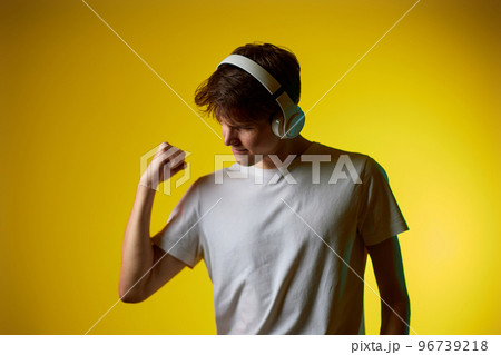 Young man listening to music with headphones Young man listening to music with headphones 96739218