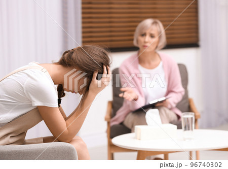 Psychotherapist working with teenage girl in office Psychotherapist working with teenage girl in office 96740302