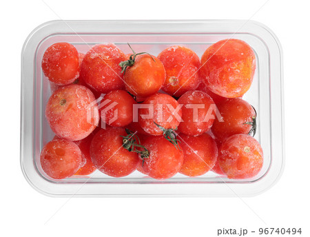 Frozen tomatoes in plastic container isolated on white, top view. Vegetable preservation 96740494
