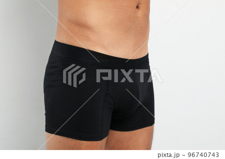 Man in black underwear on white background, closeup Man in black underwear on white background, closeup 96740743