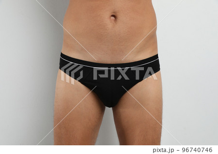Man in black underwear on white background, closeup Man in black underwear on white background, closeup 96740746