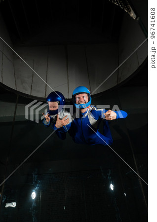 A man teaches a boy to fly in a wind tunnel. Lack of gravity. A man teaches a boy to fly in a wind tunnel. Lack of gravity. 96741608