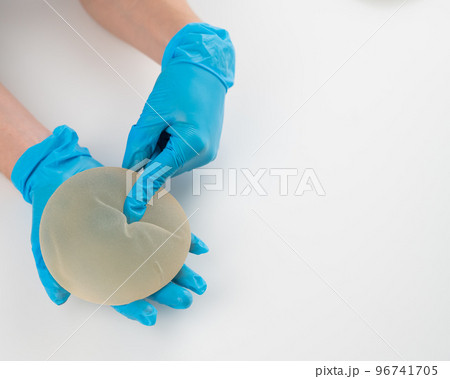 A plastic surgeon shows a breast silicone implant. A plastic surgeon shows a breast silicone implant. 96741705