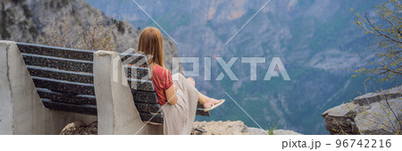 BANNER, LONG FORMAT Woman tourist on background of Breathtaking panoramic view of the Grlo Sokolovo gorge in Montenegro. In the foreground is a mountain, the flat side of which forms a cliff, and the BANNER, LONG FORMAT Woman tourist on background of Breathtaking panoramic view of the Grlo Sokolovo gorge in Montenegro. In the foreground is a mountain, the flat side of which forms a cliff, and the 96742216