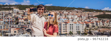 BANNER, LONG FORMAT Couple in love tourists enjoying the views of Architecture and luxury yachts in Lustica Bay, Montenegro. Travel around Montenegro concept. Go Everywhere 96742218